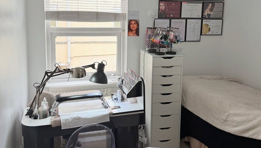 Glamorous Nails & Lashes salon in Peterborough, England, GB showcasing a stylish nail station and cozy bed.