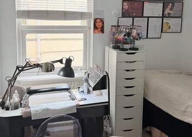 Glamorous Nails & Lashes salon in Peterborough, England, GB showcasing a stylish nail station and cozy bed.