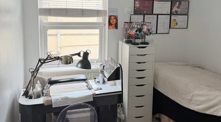 Glamorous Nails & Lashes salon in Peterborough, England, GB showcasing a stylish nail station and cozy bed.
