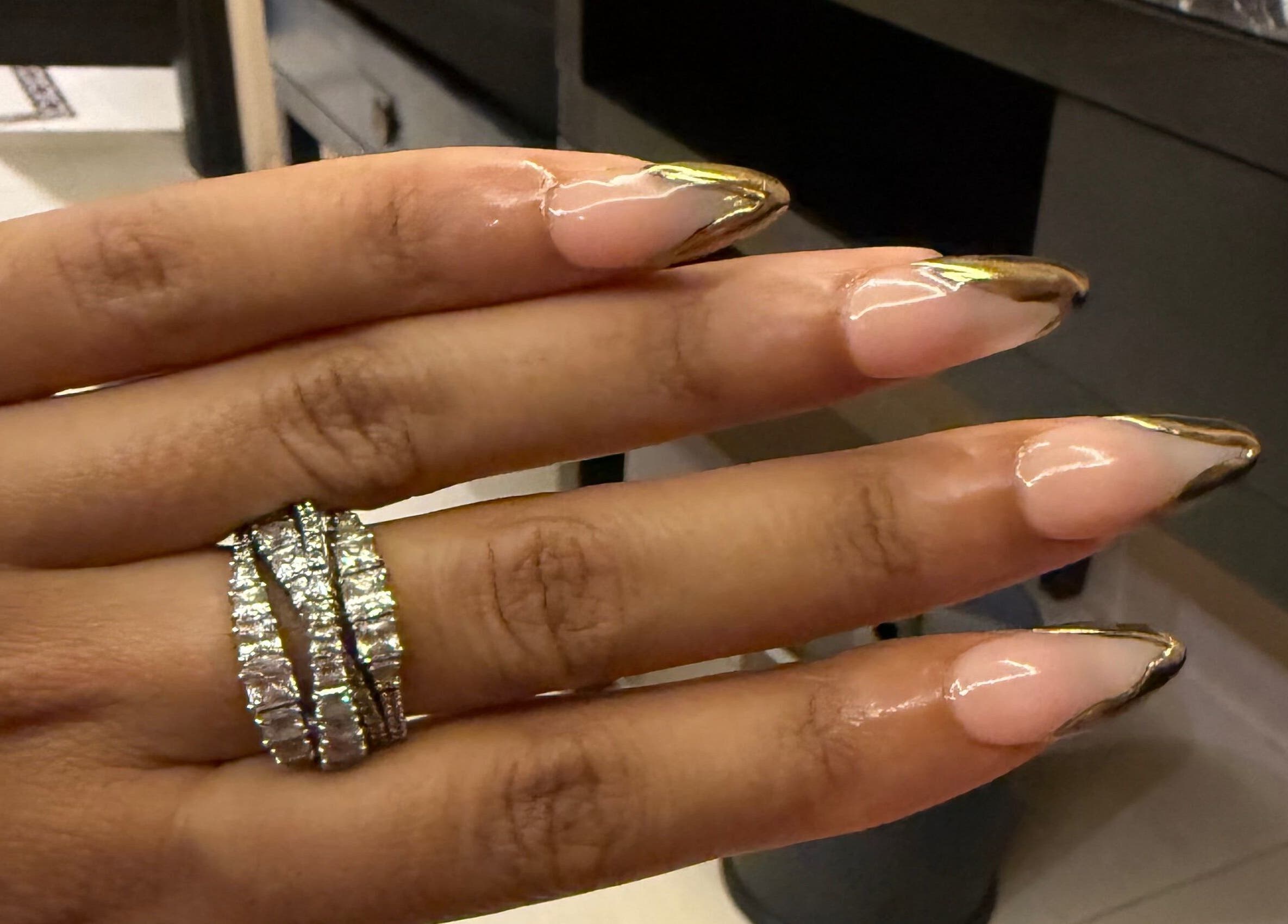 Elegant manicured nails at Glamorous Nails & Lashes in Peterborough, England, GB, showcasing gold-tipped design.