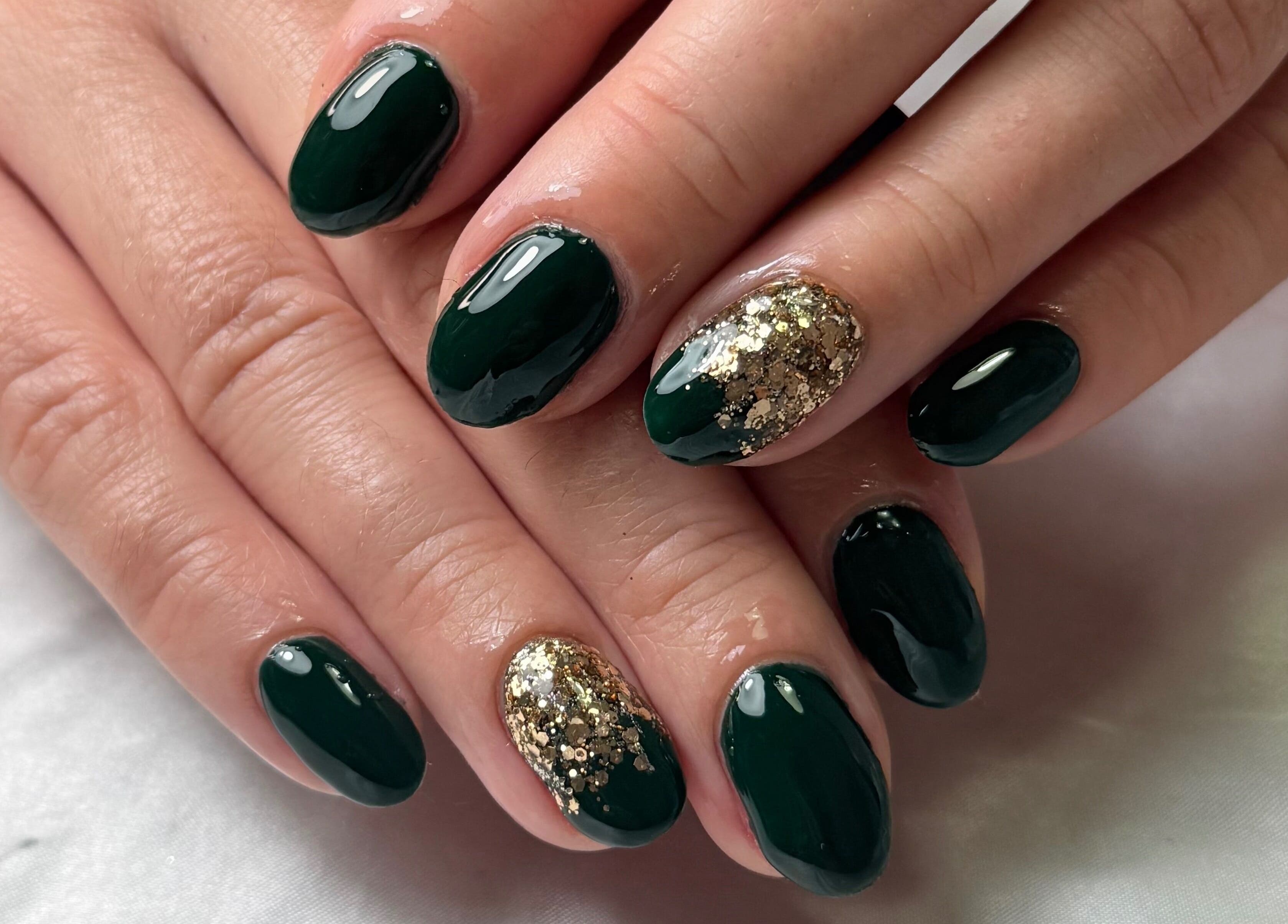 Elegant emerald and gold glitter nails at Glamorous Nails & Lashes, Peterborough, England, GB.