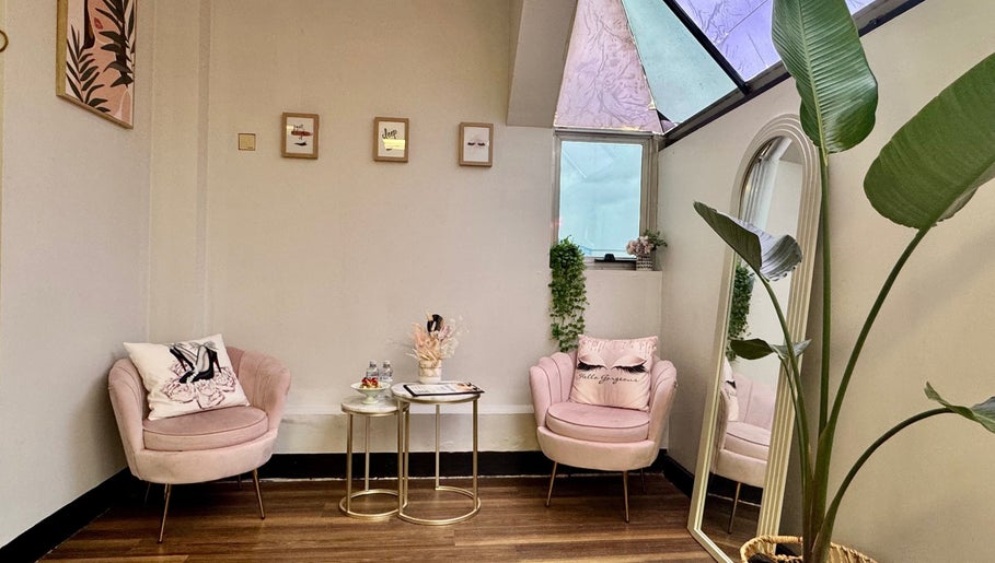 Chic waiting area at Sistar Lashes Sandy Bay, Tasmania, AU with plush chairs and decor.