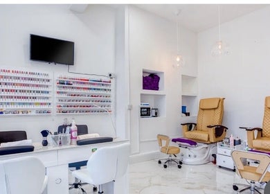Modern interior of DK nails Roehampton, featuring plush chairs, London, England, GB.