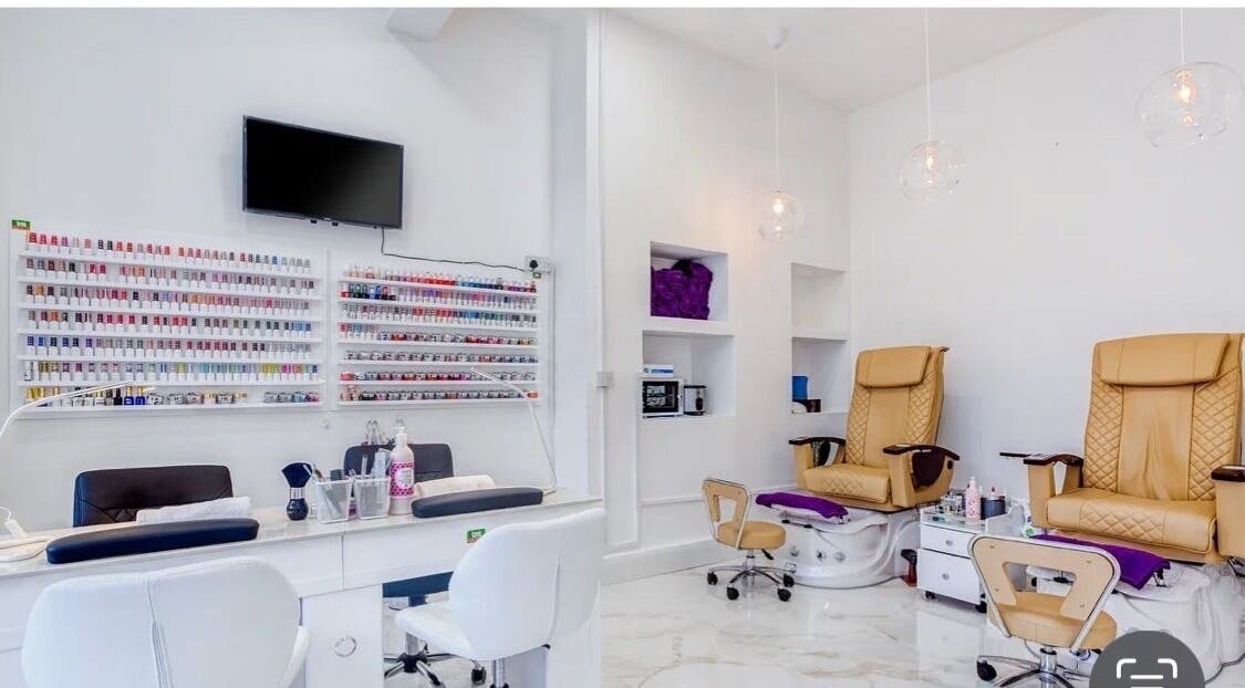Modern interior of DK nails Roehampton, featuring plush chairs, London, England, GB.