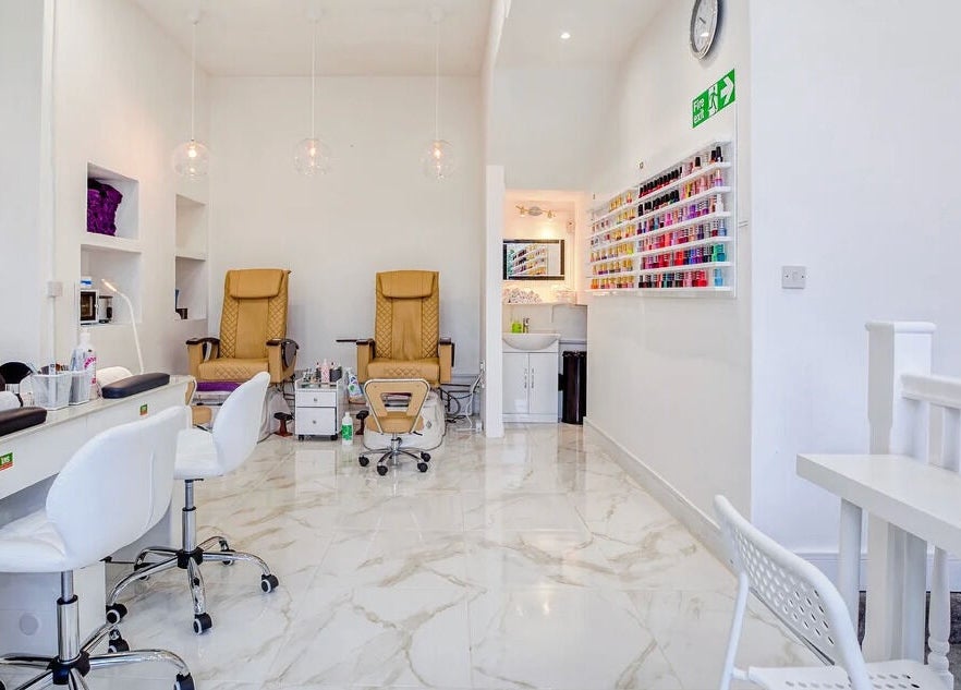 Interior of DK nails Roehampton, showcasing modern nail stations and polish shelves in London, England, GB.