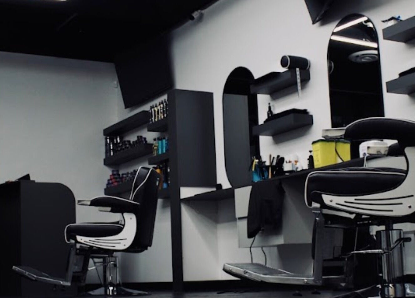 Elegant interiors of Platinum Barbershop in Edmonton, Alberta, CA featuring modern barber chairs and shelves.