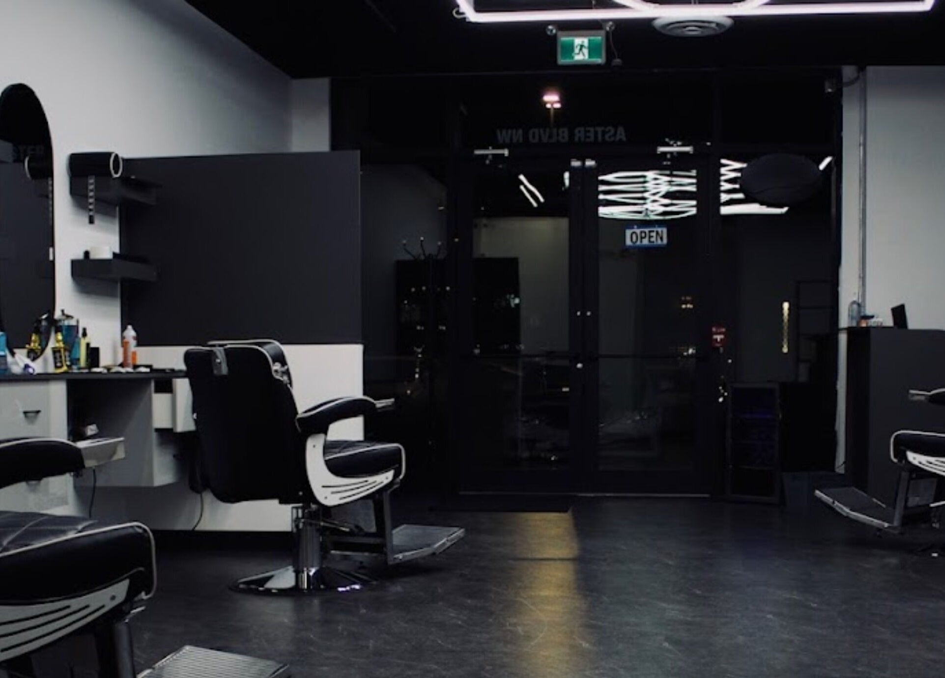 Modern interior of Platinum Barbershop in Edmonton, Alberta, CA showcasing sleek barber chairs and minimal decor.