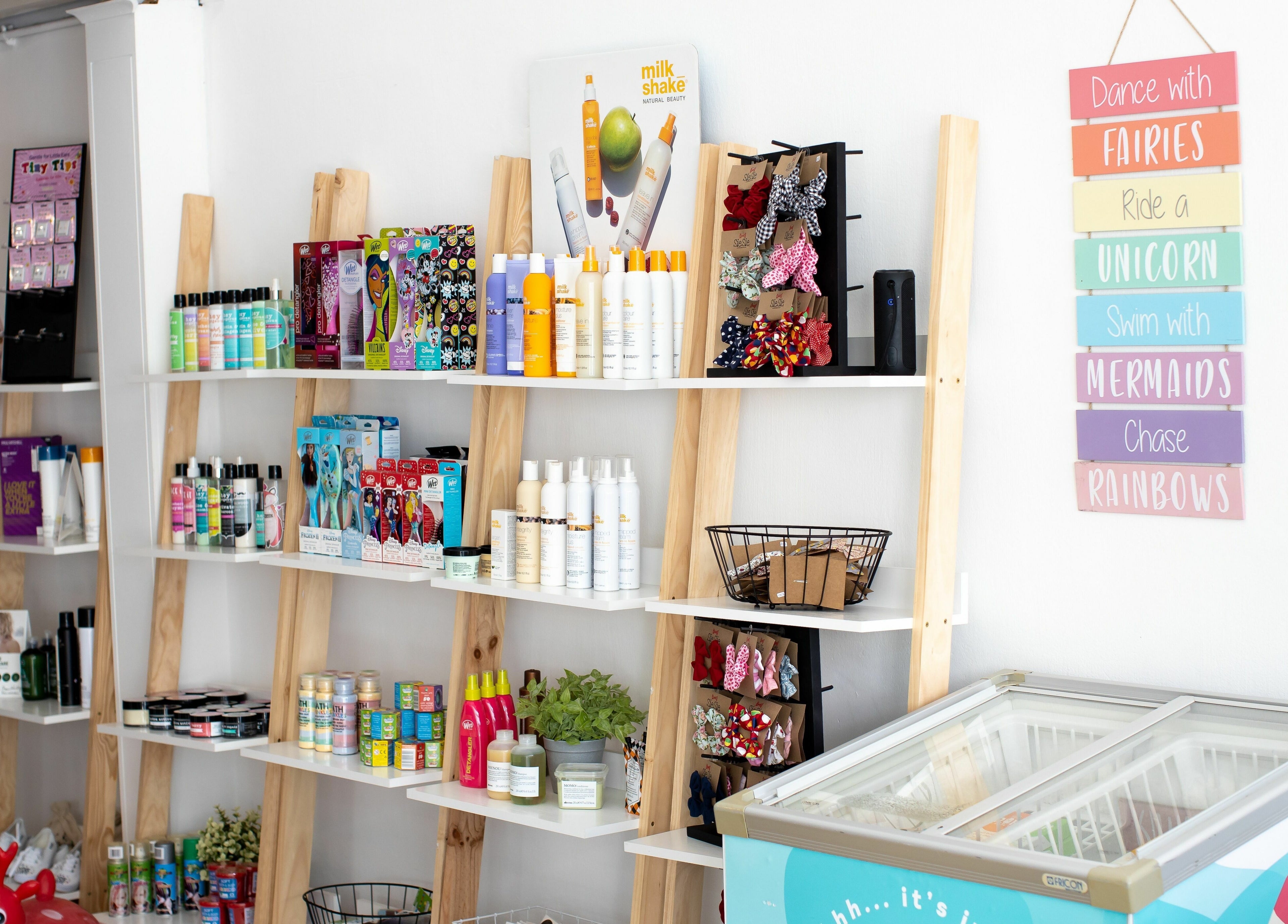 Bright product display at Snip Snap, Newlands, Cape Town, showcasing beauty items on wooden shelves.