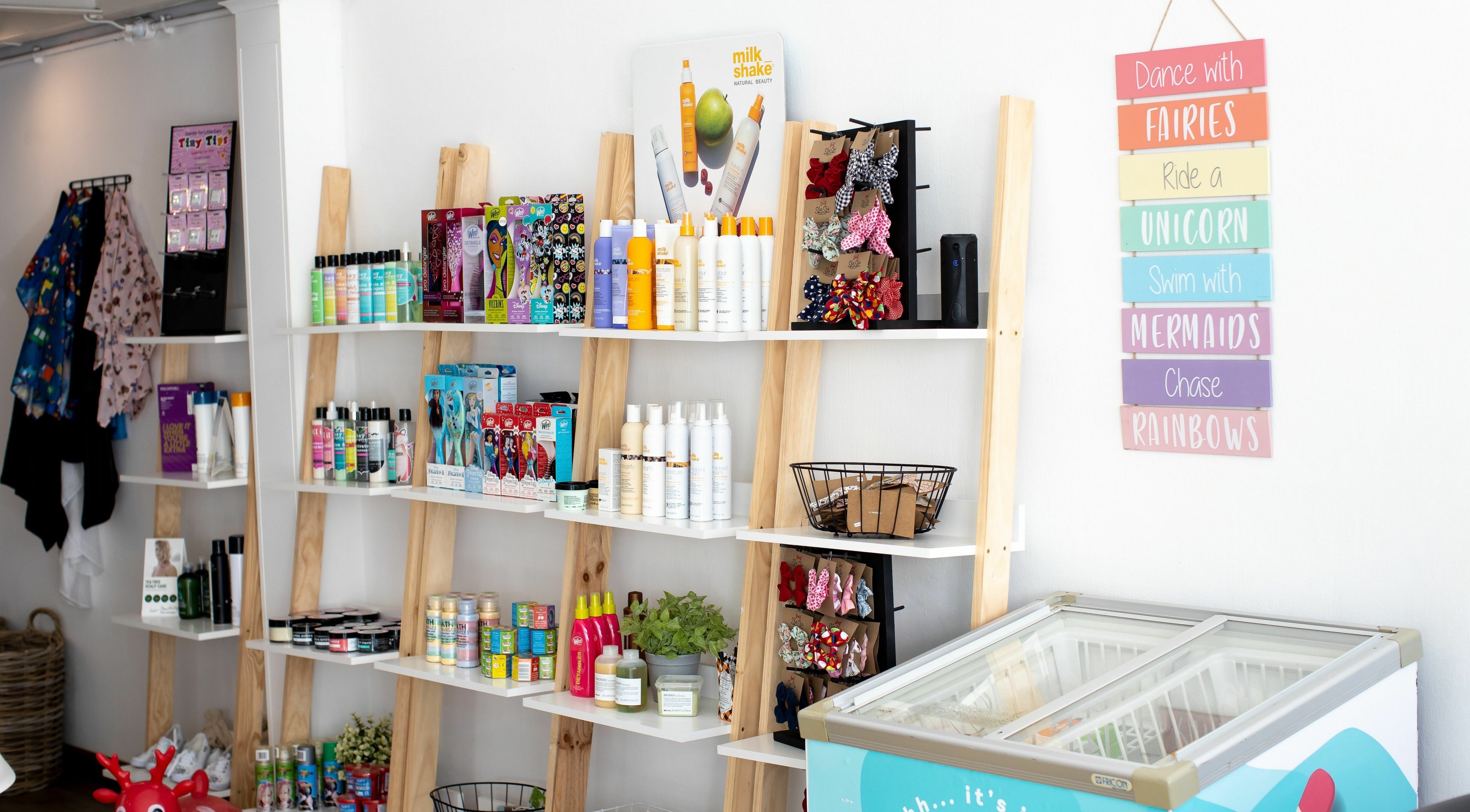 Bright product display at Snip Snap, Newlands, Cape Town, showcasing beauty items on wooden shelves.