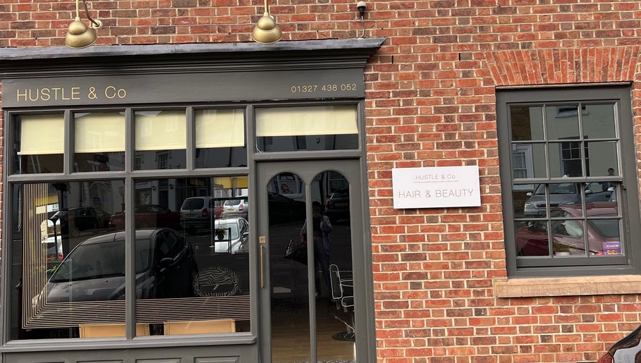 Front of Arch Envy beauty venue in Daventry, England, GB, showcasing salon windows and brick facade.