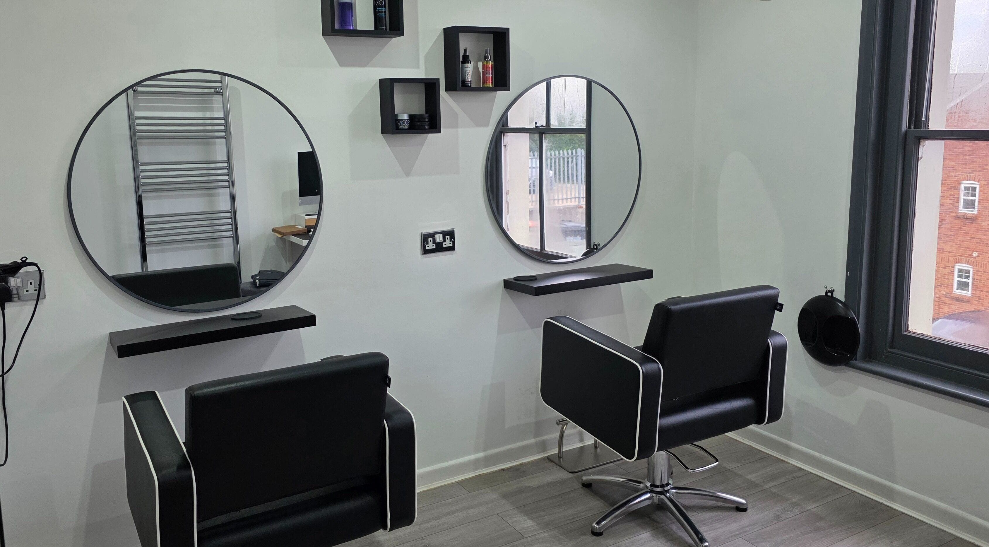 Modern styling stations at Hideaway Hair Salon, Park Gate, England, GB showcasing sleek design and comfort.