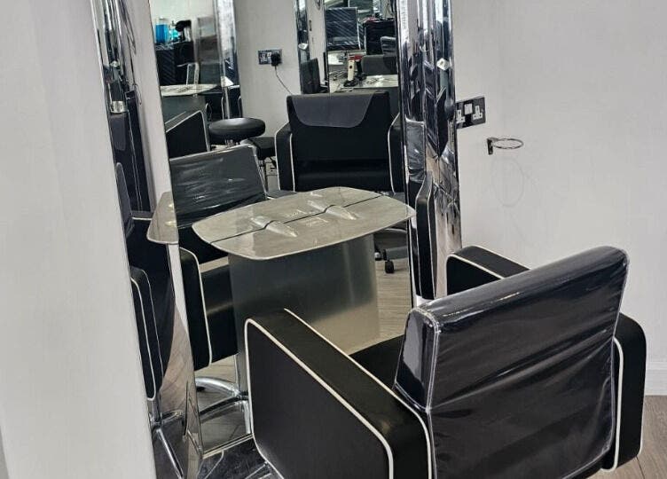 Modern styling chair and mirror setup at Hideaway Hair Salon, Park Gate, England, GB.