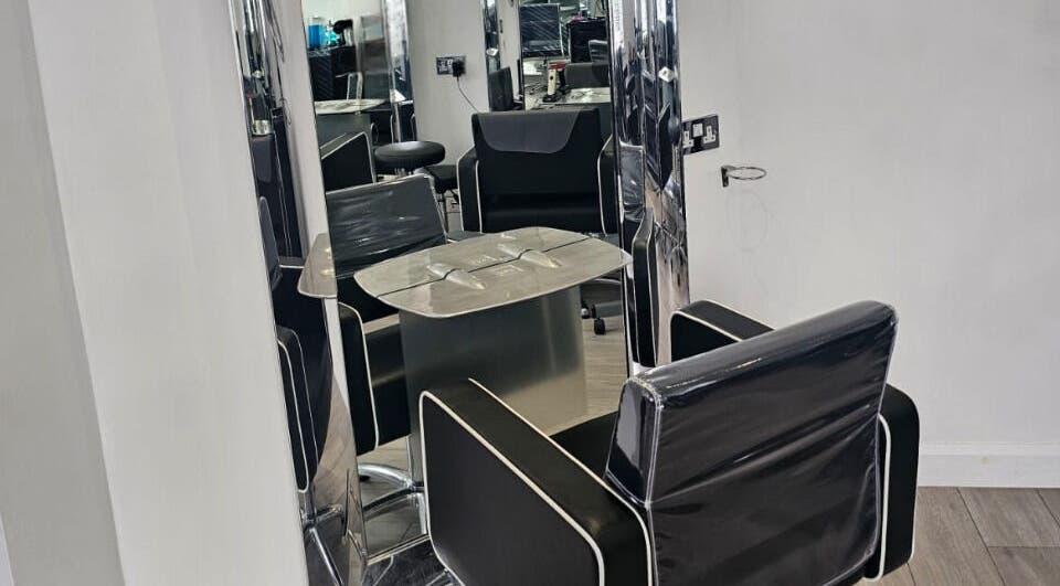 Modern styling chair and mirror setup at Hideaway Hair Salon, Park Gate, England, GB.