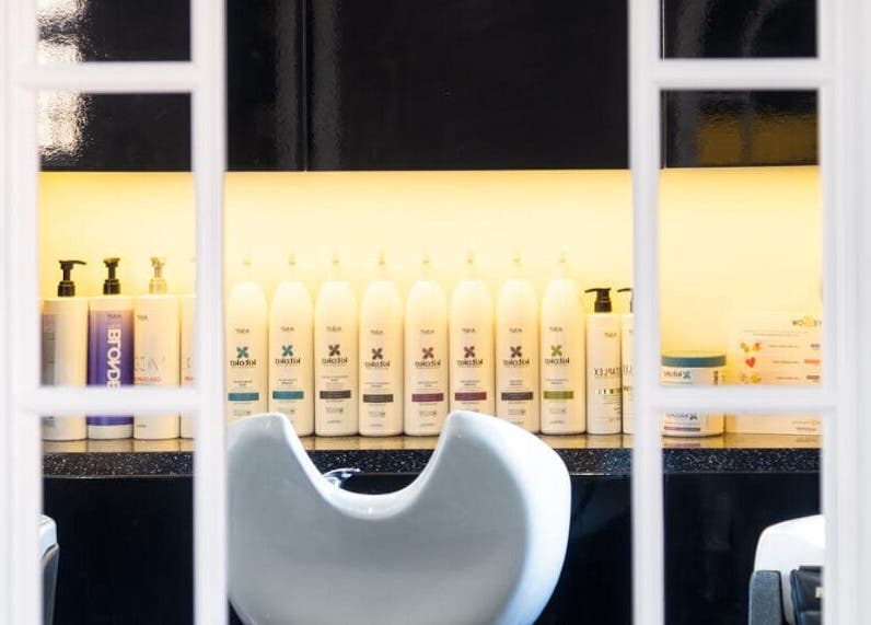 View of product display in Hideaway Hair Salon, Park Gate, England, GB, showcasing premium hair care items.