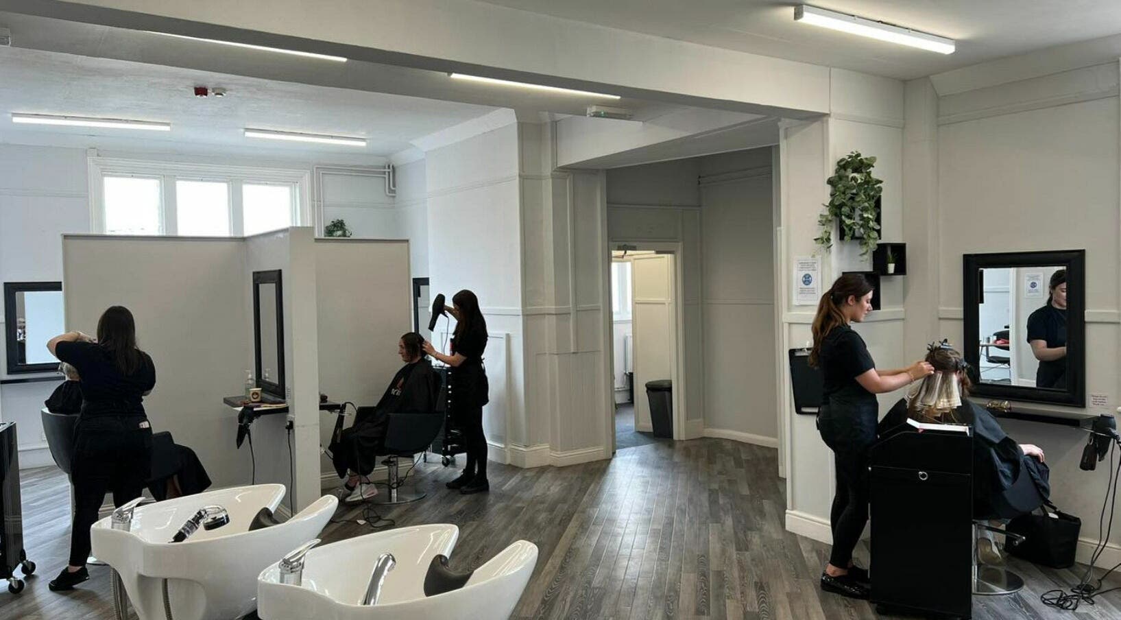 Stylists at work in GH Hair Design salon, King's Lynn, England, GB, offering modern hair treatments.