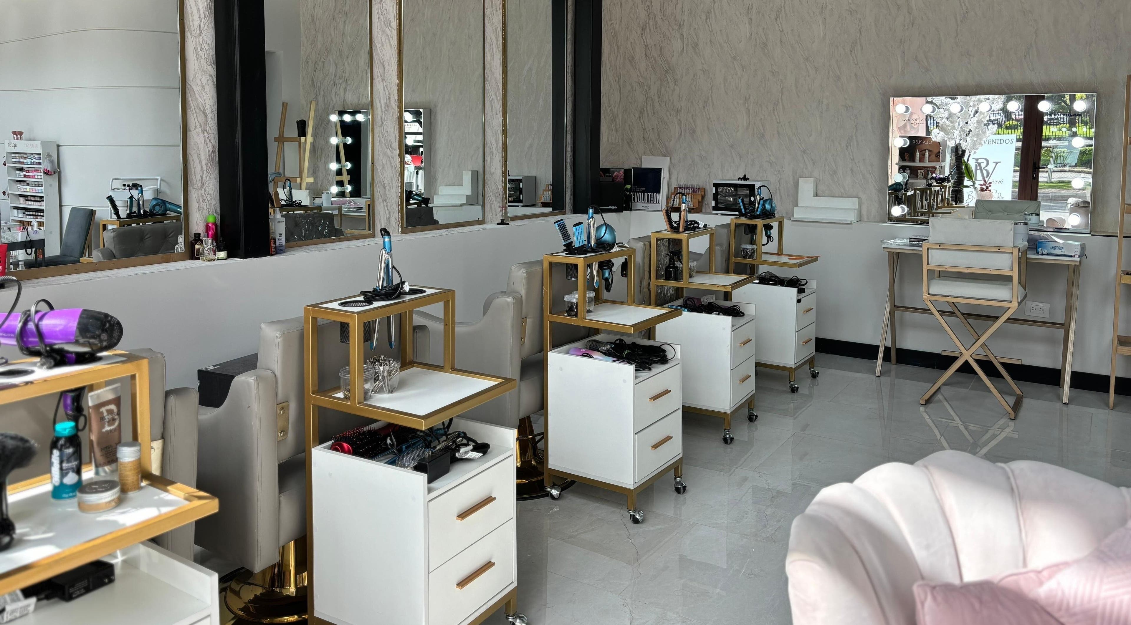 Interior moderno de Bevé Beauty Studio en Ciudad De Guatemala, Guatemala, GT, con estaciones de estilismo iluminadas.