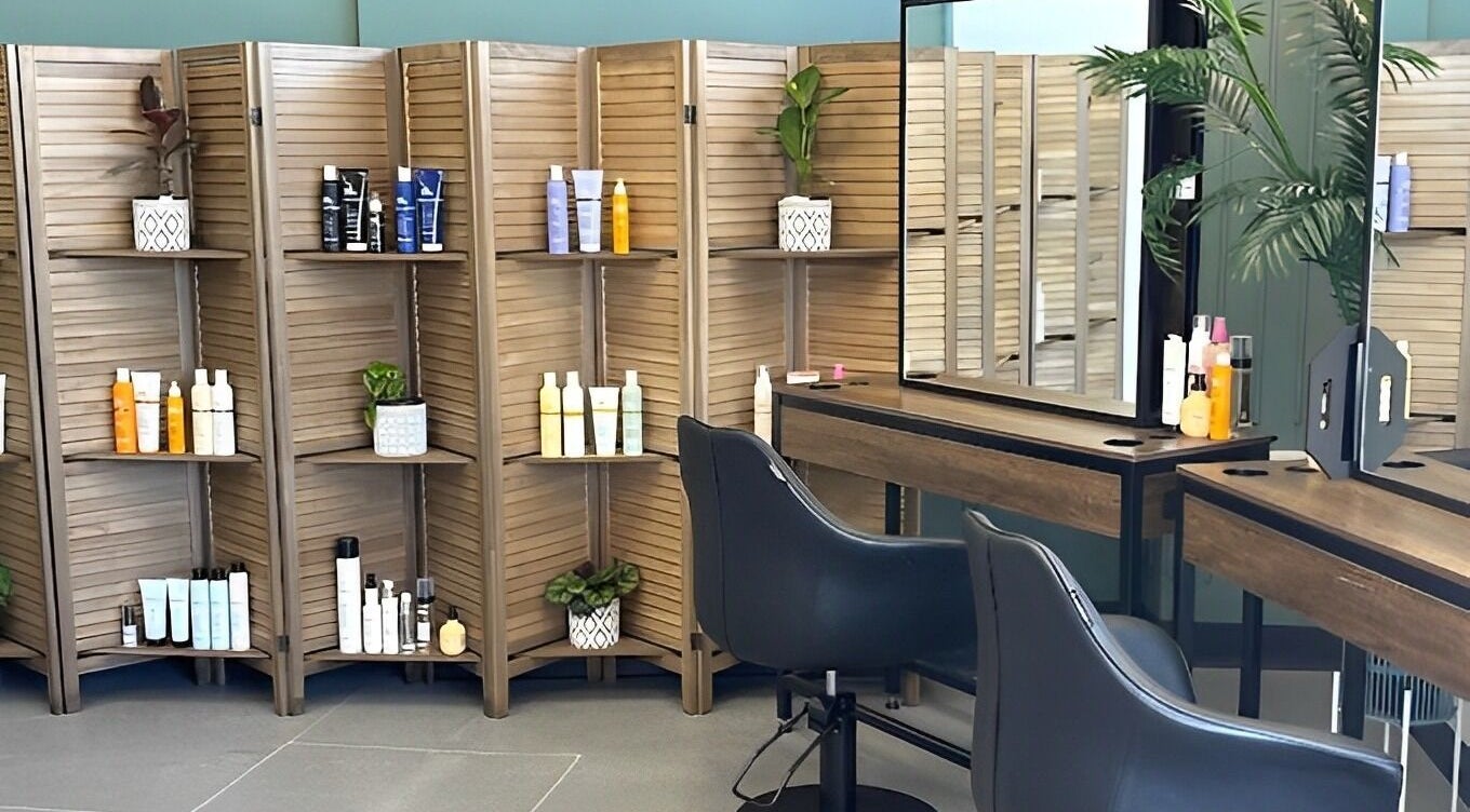 Chic salon interior at Hair Like Heaven and Beauty, Chigwell, Tasmania, AU showcasing modern styling stations and products.