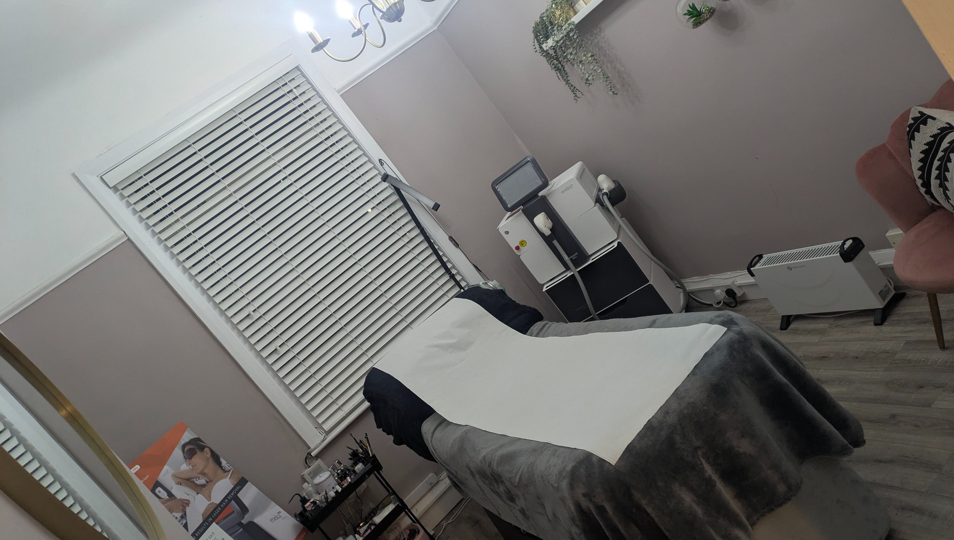 Relaxing treatment room at Kerry Osborne Make Up & Beauty, Ellesmere Port, England, GB, featuring a comfortable massage table.