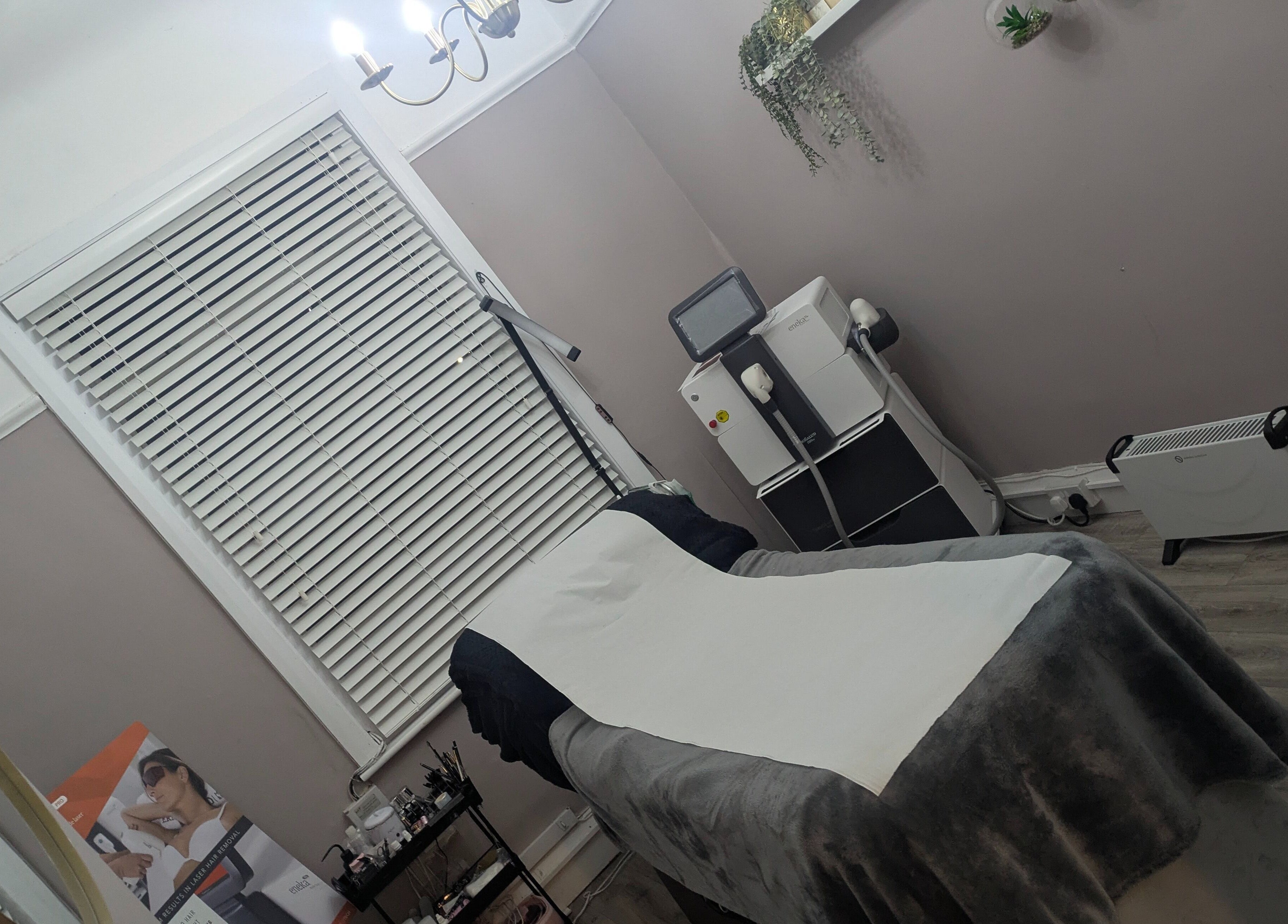 Relaxing treatment room at Kerry Osborne Make Up & Beauty, Ellesmere Port, England, GB, featuring a comfortable massage table.