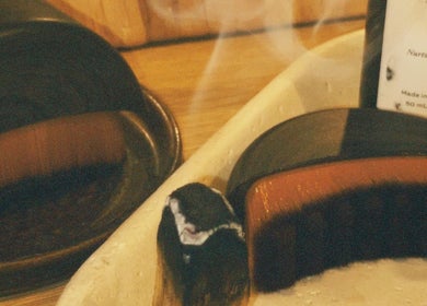 Nurturing body oil and wooden bowls at Āio Massage And Beauty Therapy, Maraetai, Auckland, NZ.