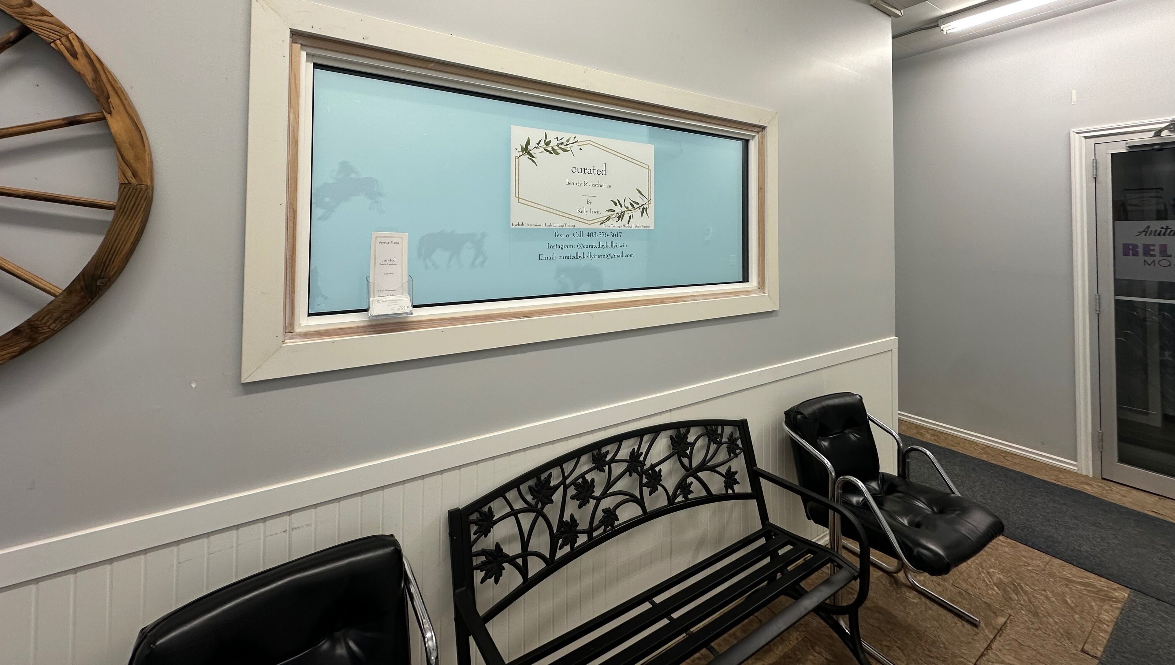 Entrance of Curated Beauty & Aesthetics in Brooks, Alberta, CA featuring stylish seating and wall decor.