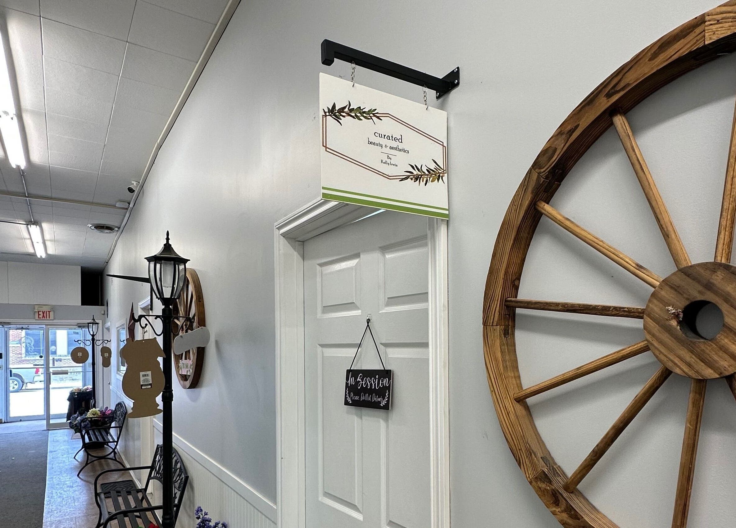 Entrance hallway of Curated Beauty & Aesthetics in Brooks, Alberta, CA, featuring elegant rustic decor.