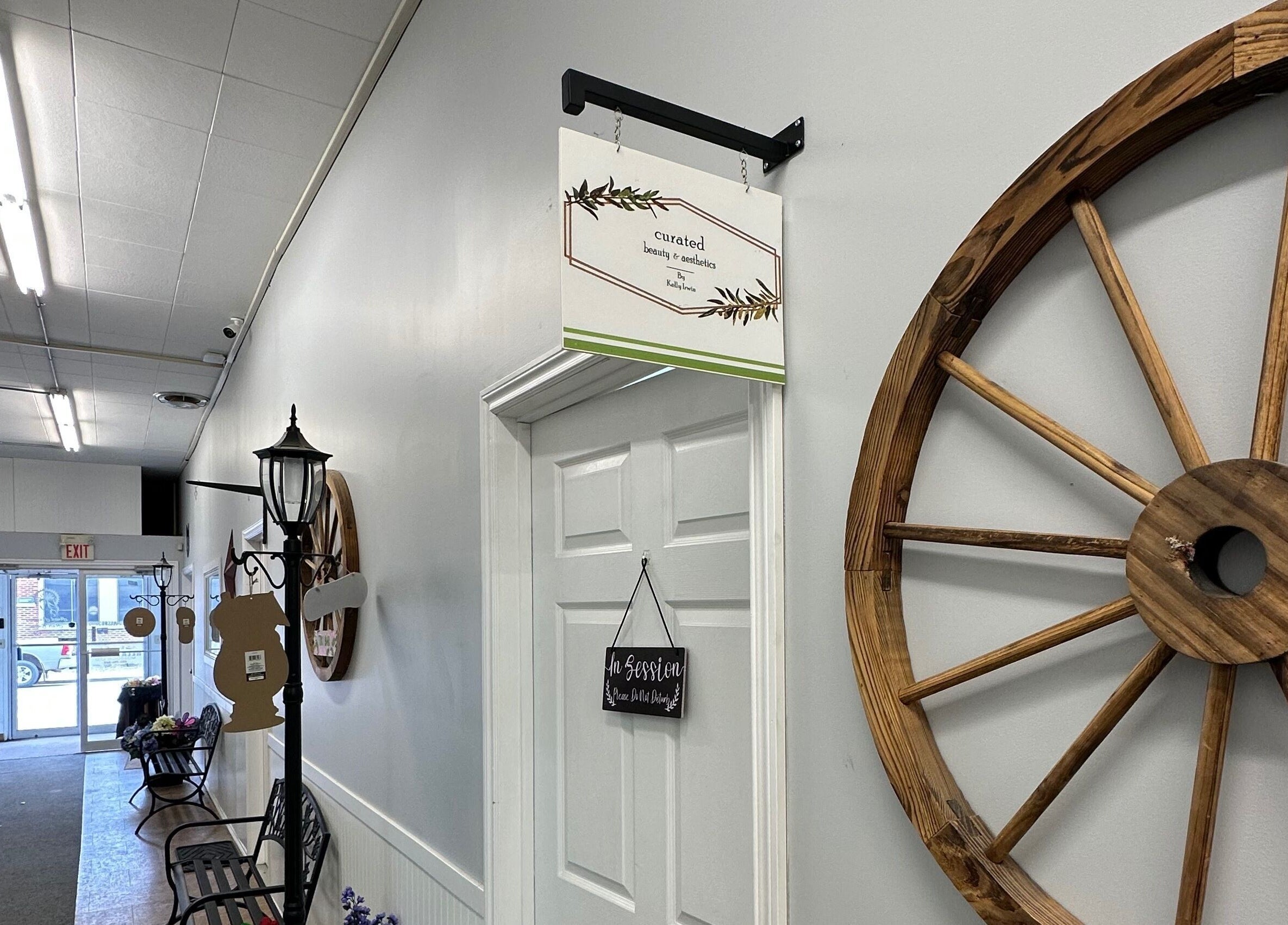 Entrance hallway of Curated Beauty & Aesthetics in Brooks, Alberta, CA, featuring elegant rustic decor.