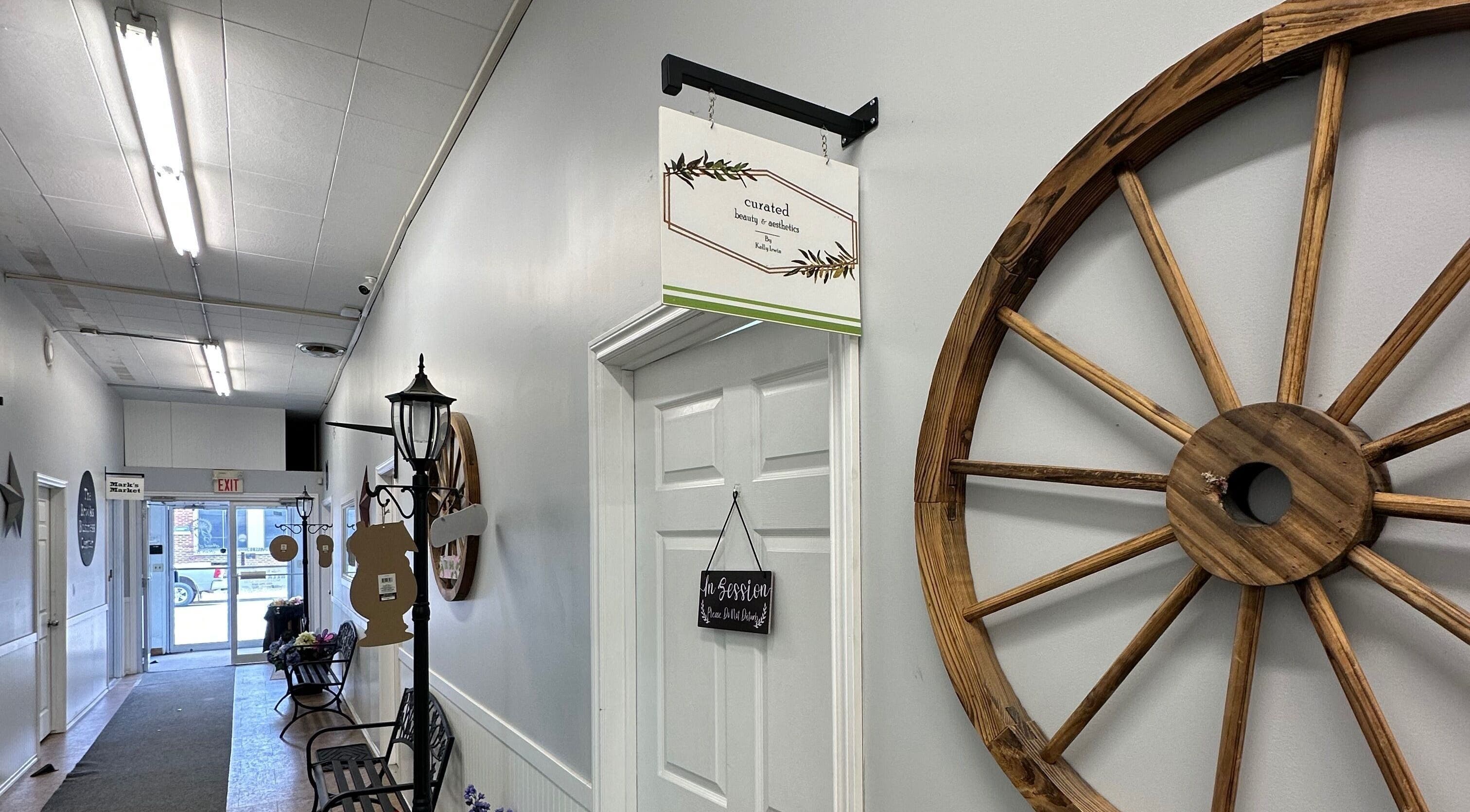 Entrance hallway of Curated Beauty & Aesthetics in Brooks, Alberta, CA, featuring elegant rustic decor.