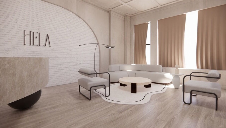 Elegant modern lounge at HELA Skincare- Midtown, New York, US, featuring cozy seating and chic decor.