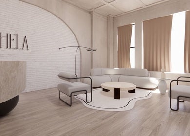 Elegant modern lounge at HELA Skincare- Midtown, New York, US, featuring cozy seating and chic decor.