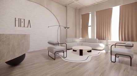 Elegant modern lounge at HELA Skincare- Midtown, New York, US, featuring cozy seating and chic decor.