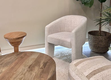 Cozy seating area at HELA Skincare- Midtown, New York, featuring modern furniture and lush greenery.