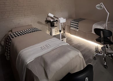 Elegant spa room at HELA Skincare- Midtown, New York, featuring stylish massage beds and ambient lighting.