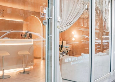 HELA Skincare- SoHo entrance reflecting New York, New York, US streetscape, inviting atmosphere.