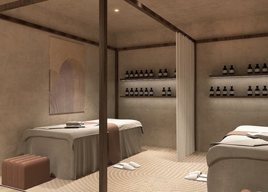 HELA Skincare- Flushing spa room with soft lighting in New York, New York, US. Two massage tables and skincare products.