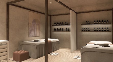 HELA Skincare- Flushing spa room with soft lighting in New York, New York, US. Two massage tables and skincare products.