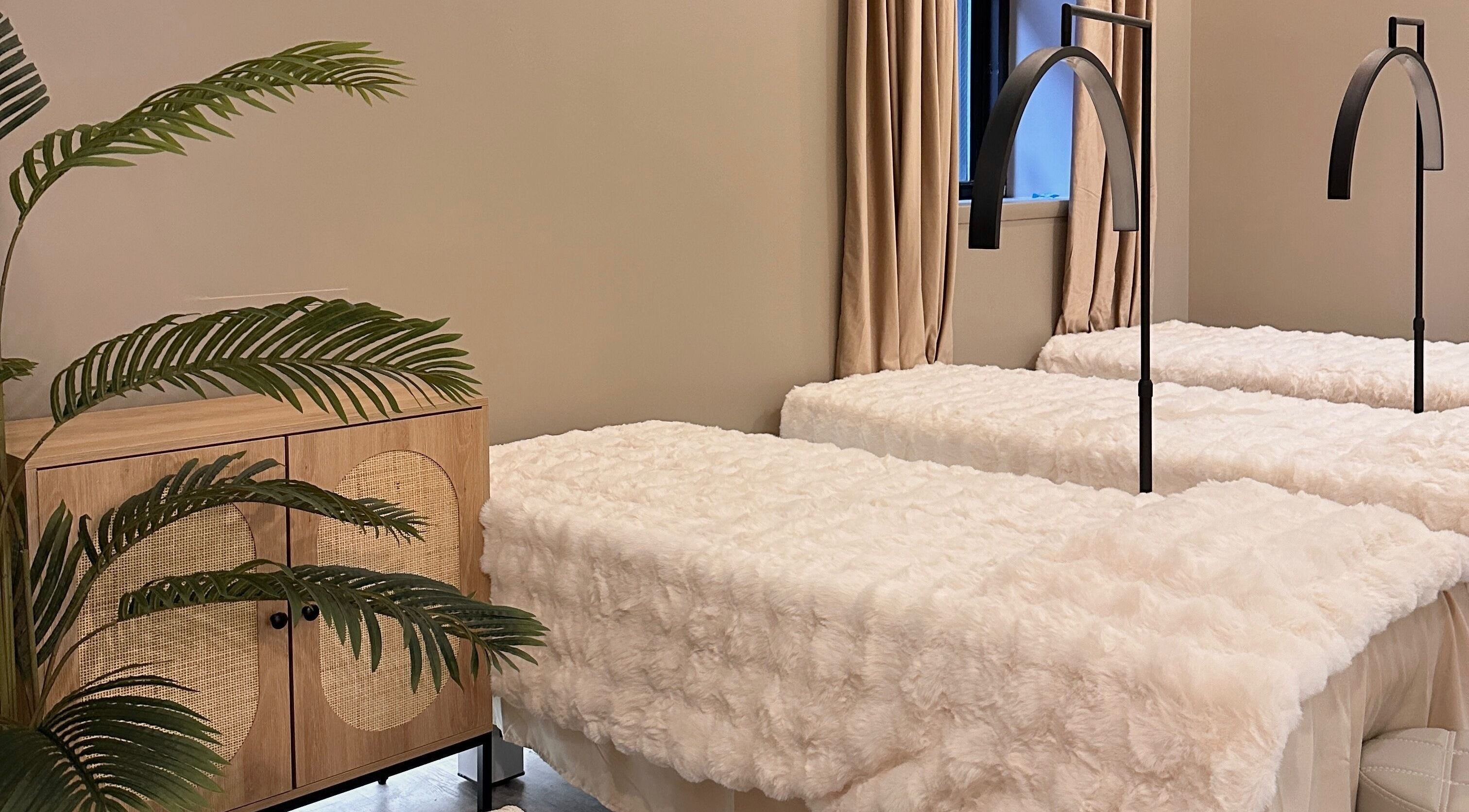 Luxurious treatment beds at HELA Skincare- Midtown, New York, New York, US with plush decor.