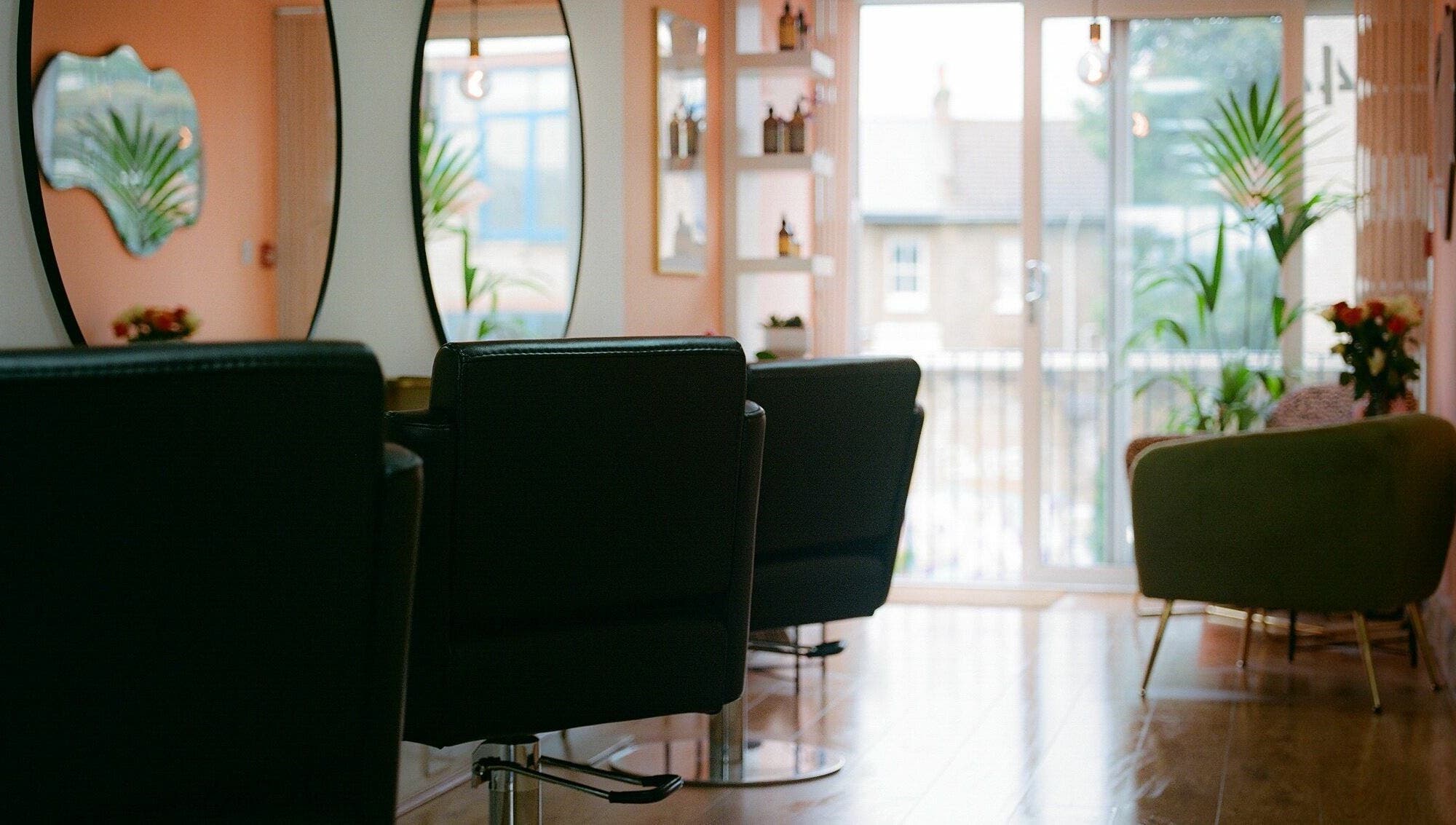 Spacious salon with modern chairs and mirrors at Barnet Fair, London, England, GB.