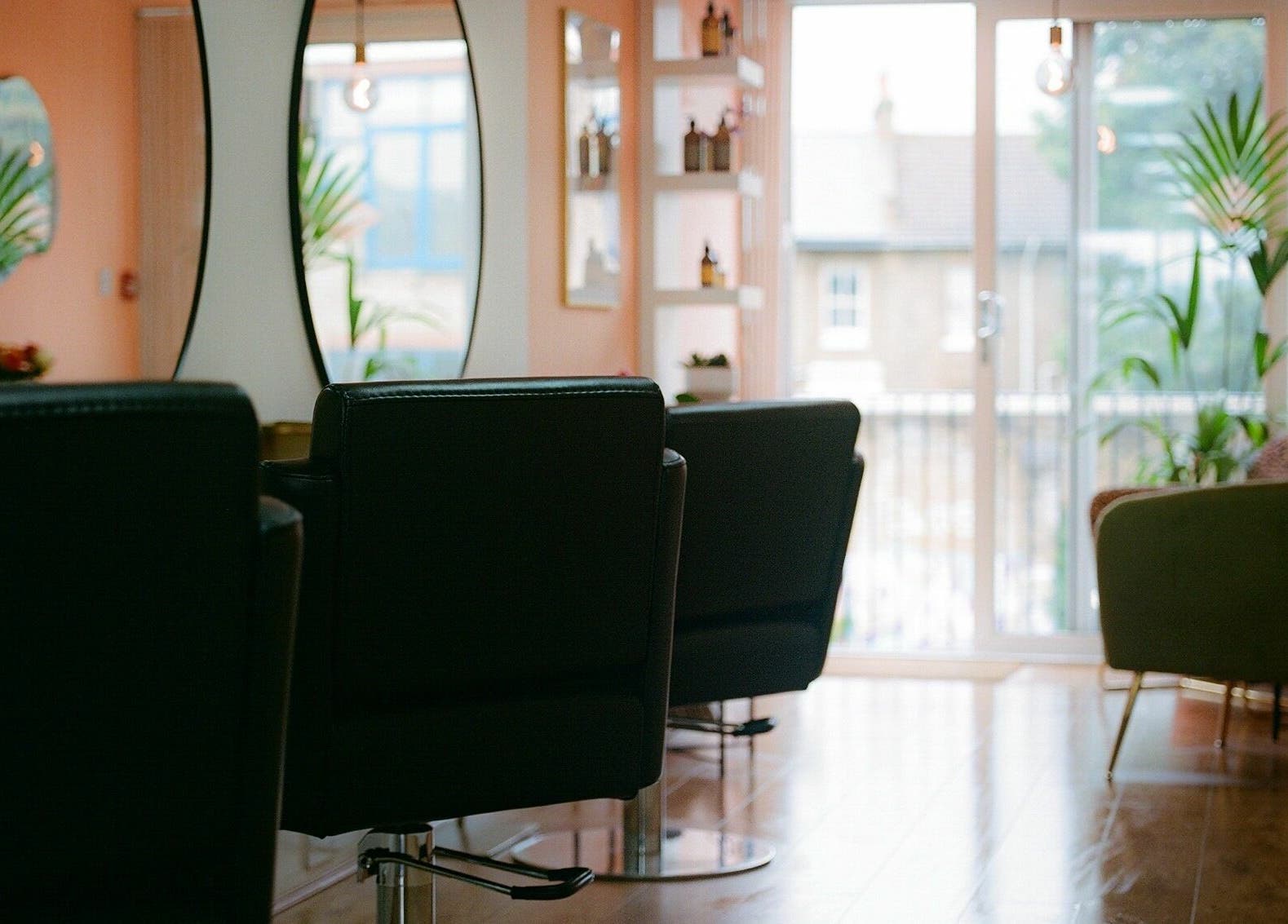 Spacious salon with modern chairs and mirrors at Barnet Fair, London, England, GB.