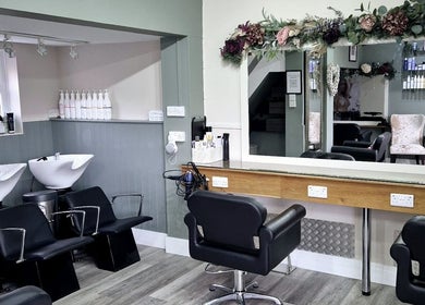 Interior of Affinity Hair Design in Waddesdon, England, GB, featuring elegant chairs and stylish decor.