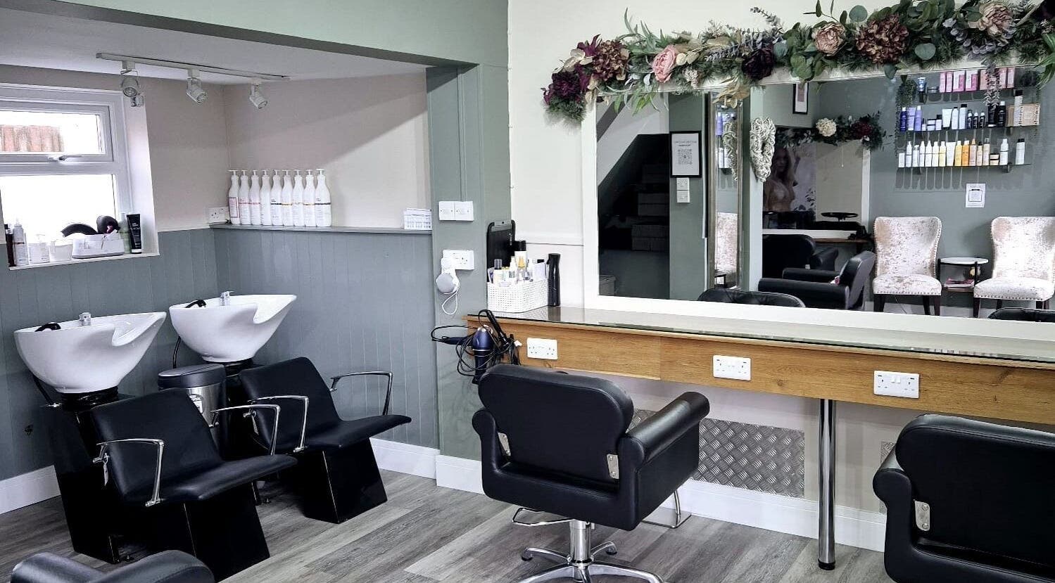 Interior of Affinity Hair Design in Waddesdon, England, GB, featuring elegant chairs and stylish decor.