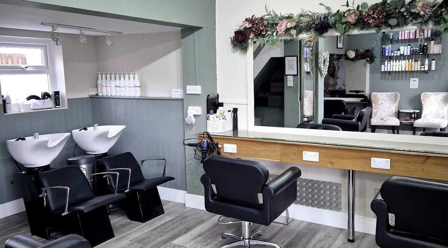 Interior of Affinity Hair Design in Waddesdon, England, GB, featuring elegant chairs and stylish decor.