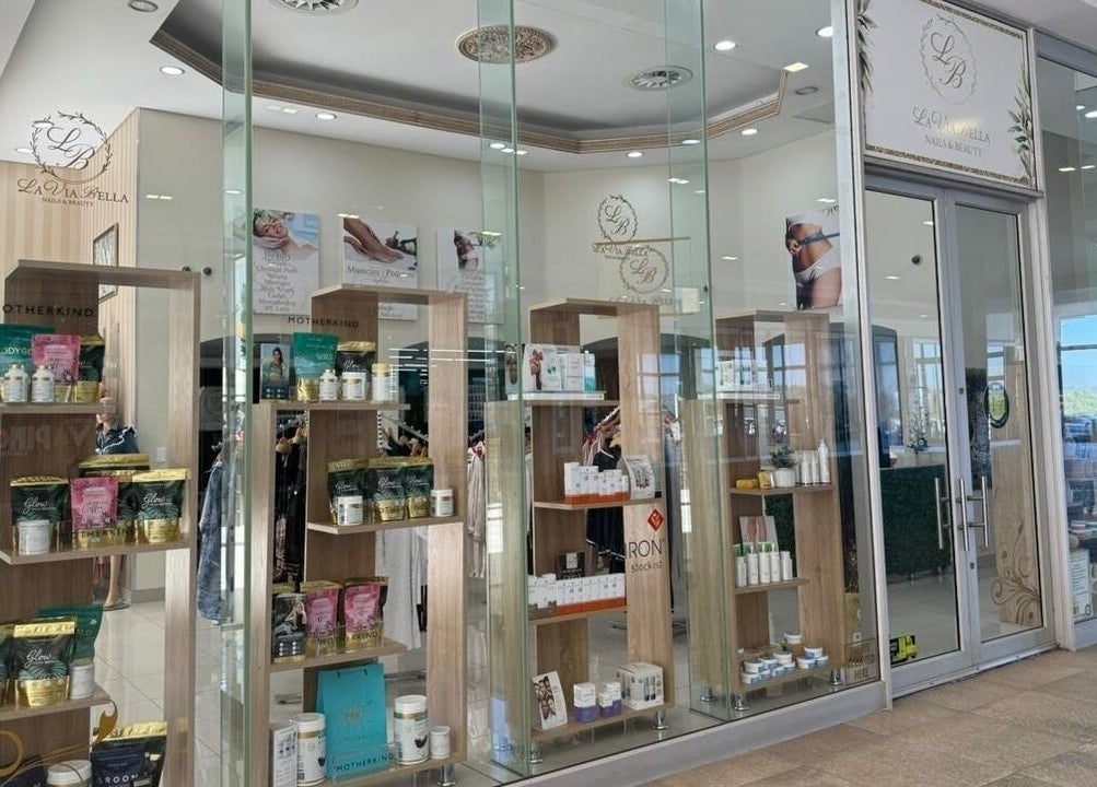 Elegant glass facade of La Via Bella Nails & Beauty in Johannesburg, Gauteng, ZA, showcasing luxury products.