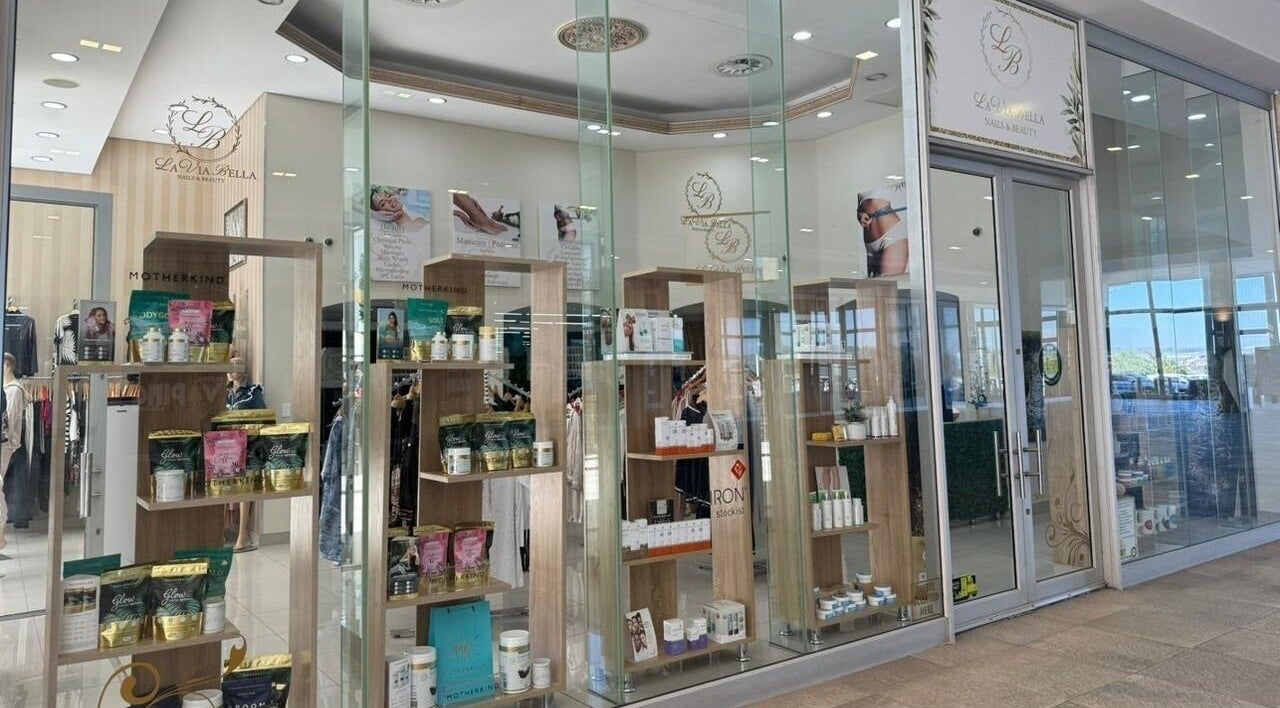 Elegant glass facade of La Via Bella Nails & Beauty in Johannesburg, Gauteng, ZA, showcasing luxury products.