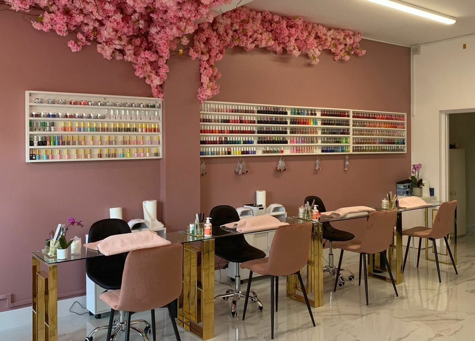 Elegant nail salon at Glam Studio, Erith, England, GB with pink decor and nail polish display.