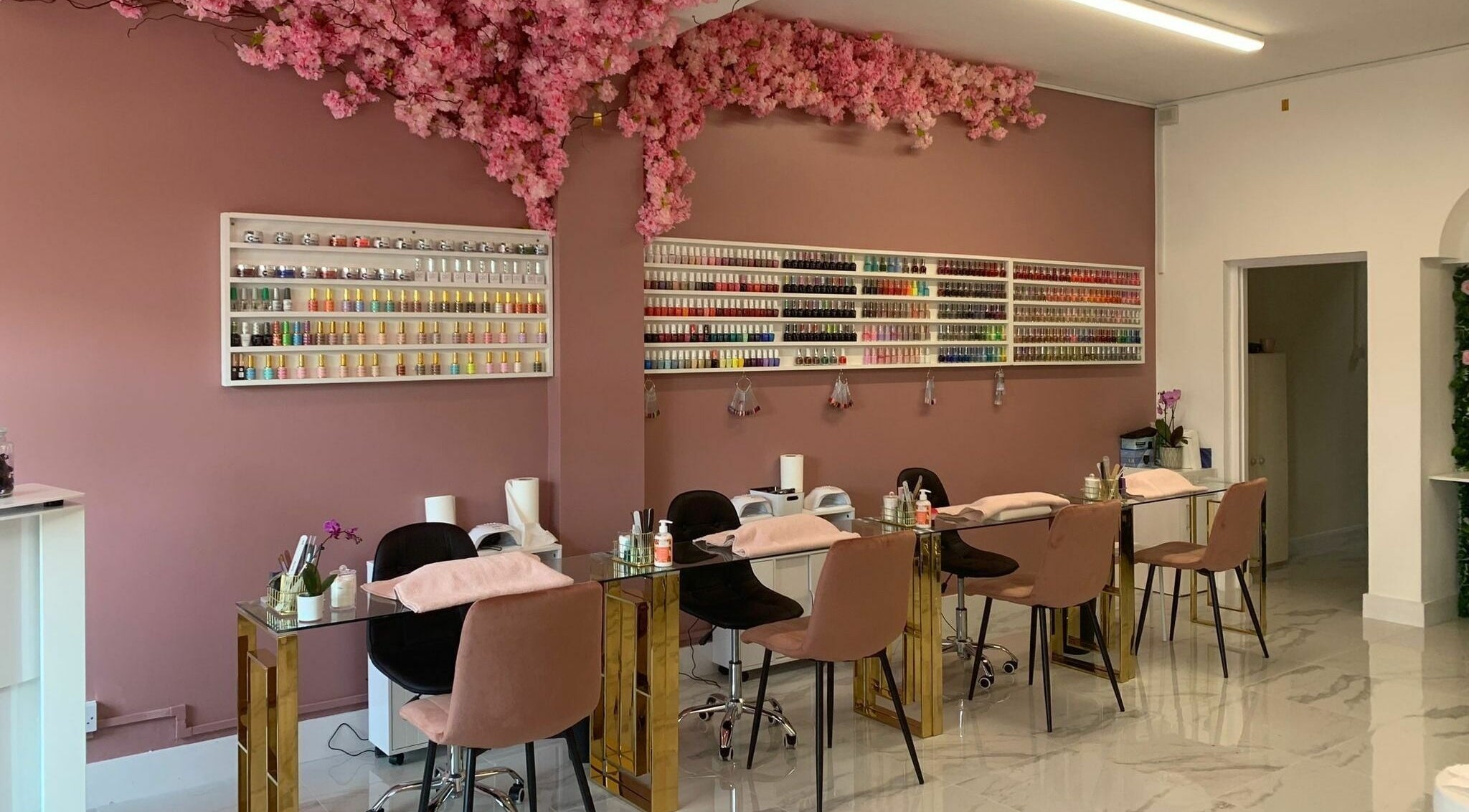 Elegant nail salon at Glam Studio, Erith, England, GB with pink decor and nail polish display.