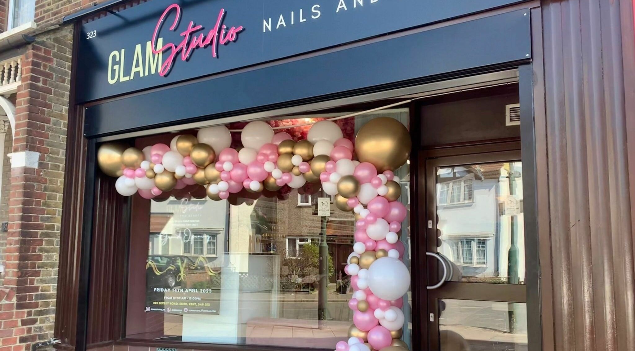 Glam Studio front adorned with pink and gold balloons in Erith, England, GB.
