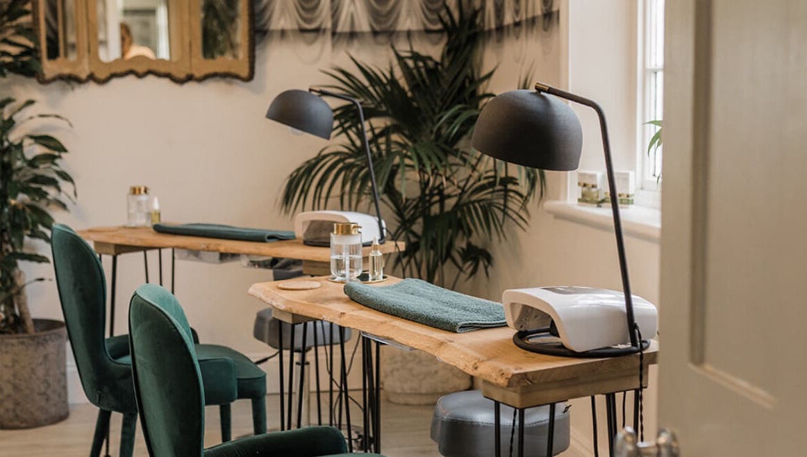 Chic Treatment Rooms in Hastings, England, GB, showcasing elegant green chairs and wooden tables.