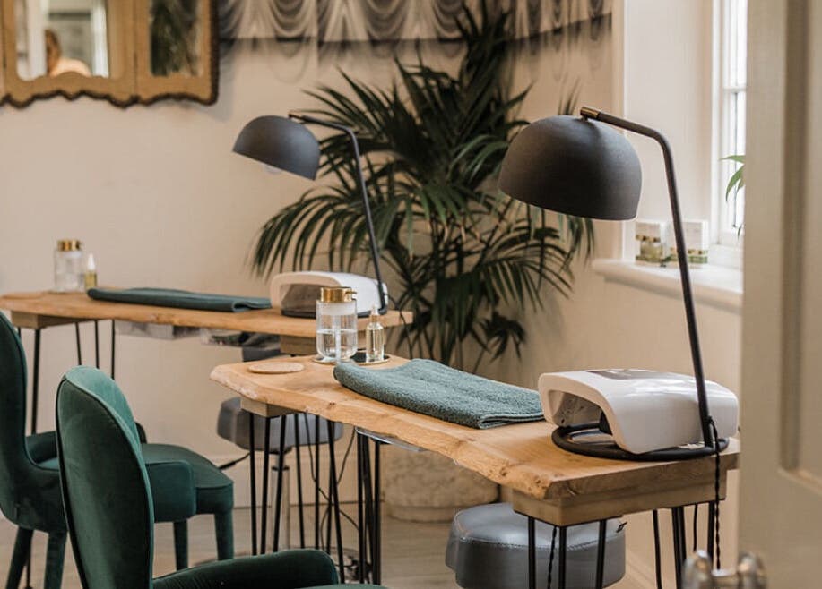 Chic Treatment Rooms in Hastings, England, GB, showcasing elegant green chairs and wooden tables.