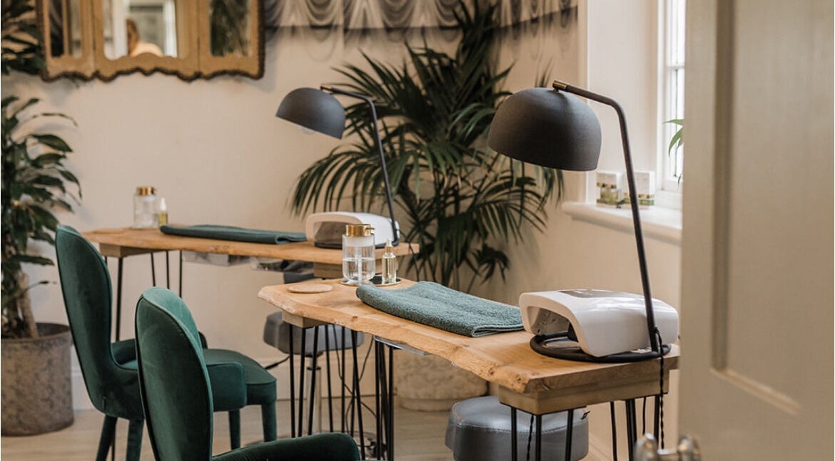 Chic Treatment Rooms in Hastings, England, GB, showcasing elegant green chairs and wooden tables.